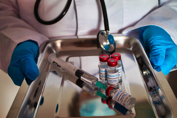 nurse with covid_19 vaccine tray for vaccination