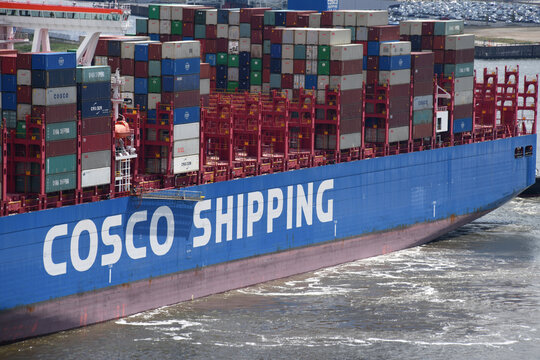 Hamburg, Germany - May 29, 2019: Container Ship COSCO SHIPPING ARIES (Length 399 meters, 20000 TEU) is leaving Hamburg Harbour