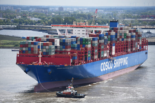 Hamburg, Germany - May 29, 2019: Container Ship COSCO SHIPPING ARIES (Length 399 meters, 20000 TEU) is leaving Hamburg Harbour