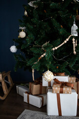 Christmas decorations and candles, gifts near the festive green Christmas tree