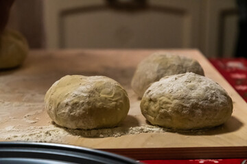 Preparing bread for homemade pizza, an Italian tradition