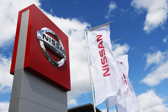 Celle, Lower Saxony, Germany - June 8, 2019: dealership sign of Nissan against blue sky in Celle, Germany - Nissan is a Japanese multinational automaker