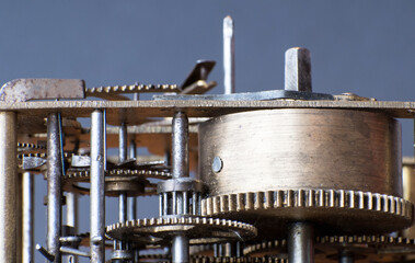 Close up side view of inside clock work. vintage Mechanic handmade instrument. Gearwheels detail of antique timepiece.