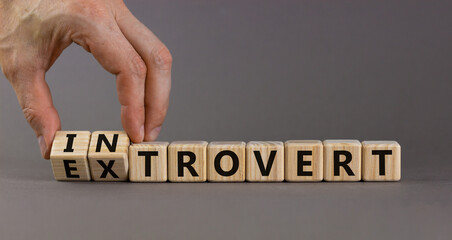 Introvert or extrovert symbol. Hand turns cubes and changes the word 'introvert' to 'extrovert'....