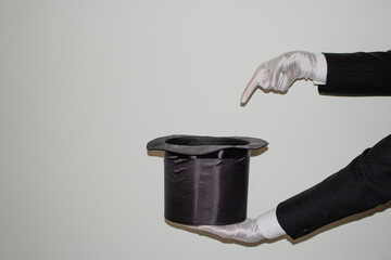 Portrait of young black Illusionist magician doing magic with a top hat