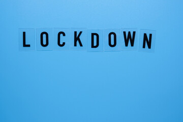 The word lockdown on a blue background close-up.