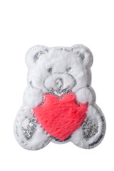 Fluffy white Teddy bear with red heart patch isolated on white background