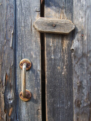 Old vintage door handles. Rusty metal locks and latches. Protective devices for wooden yard gates
