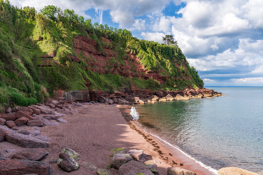 Clouds over the beach in Maidencombe, Torbay, England, UK