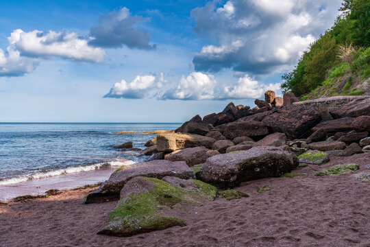 Clouds over the beach in Maidencombe, Torbay, England, UK