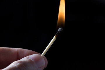 Holding a lit/burning match