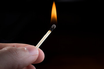 Holding a lit/burning match