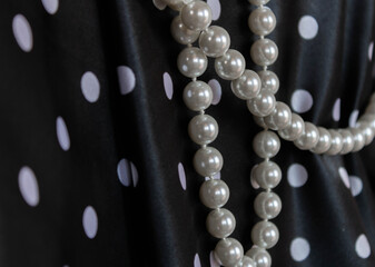 Pearls on black background with white dots