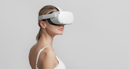 young woman in vr helmet on her head on a light background