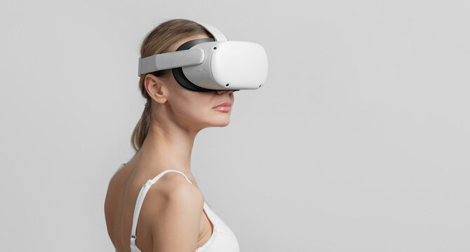young woman in vr helmet on her head on a light background