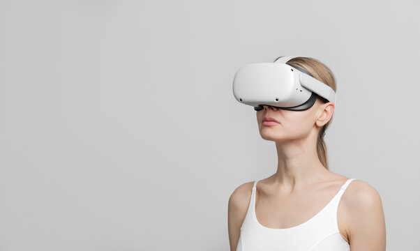 young woman in vr helmet on her head on a light background
