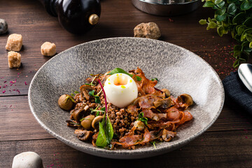 plate with buckwheat porridge, fried bacon and eggs. rich dish for the meal buckwheat porridge with egg and bacon, healthy breakfast