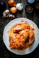 Fresh raw chicken on wooden table prepared to roast 

