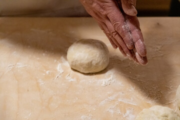 Preparing bread for homemade pizza, an Italian tradition