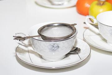 empty cup and strainer on the table