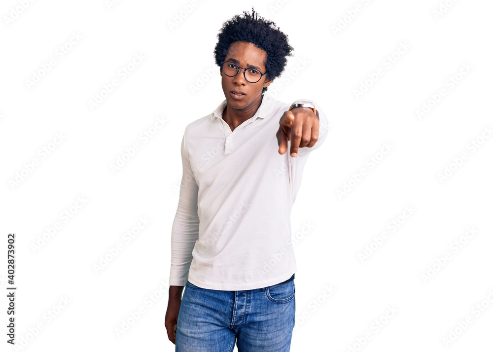 Sticker handsome african american man with afro hair wearing casual clothes and glasses pointing displeased 