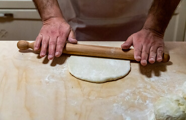 Preparing bread for homemade pizza, an Italian tradition