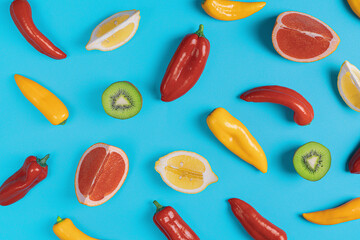 Lemon, kiwi,grapefruit,red and yellow chili pepper pattern on blue background.