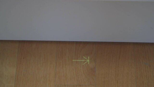 Digital sign of dishwasher on parquet in kitchen