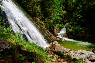 gorgeous waterfall over a steep wall in the green nature