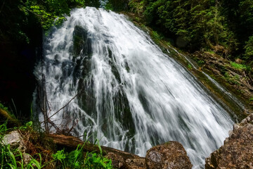 Naklejka premium gorgeous large waterfall in the mountains while hiking