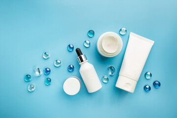 Flat lay composition with skin care products on blue background
