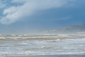 Italy Tuscany Maremma Grosseto, Marina di Grosseto beach, view of the stormy sea, Castiglione della Pescaia in the background