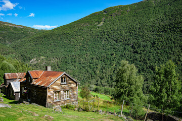 Fototapeta na wymiar Small cabin in a landscape with mountains in Norway