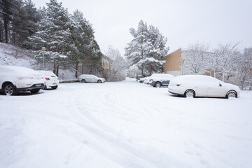cars in the snow in the parking lot. Concept, snowy winter, utilities, snow removal