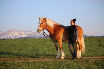 Fototapeta na wymiar Portrait of trainer and dressage horse on mountain meadow
