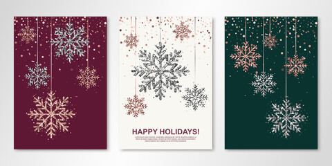Happy Holidays banners set with rose gold and silver hanging snowflakes. Vector winter design templates for invitations, greeting cards. All isolated and layered