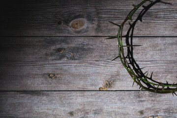 Close up of crown of thorns of Jesus on top of the holy bible on wooden table can be used for...