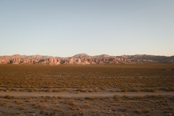 Fototapeta na wymiar Dirt road across the desert near Uspallata, Mendoza, Argentina.