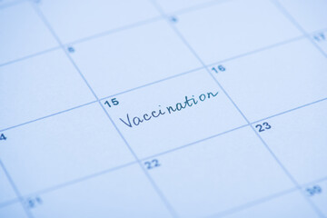 Vaccination concept. Close up view photo of word vaccination written on calendar cell