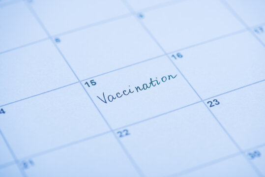Vaccination concept. Close up view photo of word vaccination written on calendar cell - Powered by Adobe