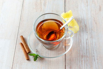 Infusion of hot tea with lemon and cinnamon