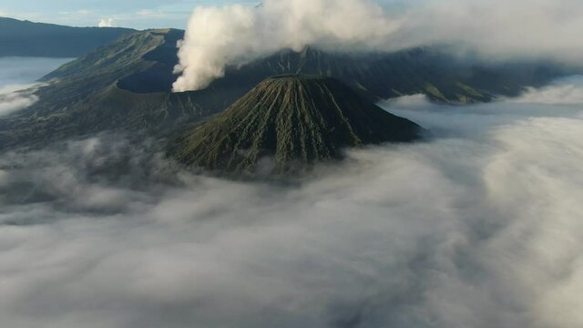 Crater with active volcano smoke in East Jawa, Indonesia. Aerial view of volcano crater Mount Gunung Bromo is an active volcano