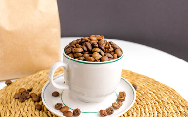 Coffee bean mug close-up with paper packaging in the background.