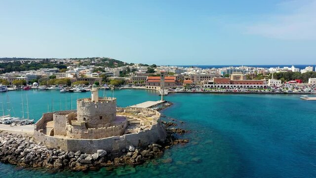 Mandraki port with deers statue, where The Colossus was standing and fort of St. Nicholas. Rhodes, Greece. Hirschkuh statue in the place of the Colossus of Rhodes, Rhodes, Greece