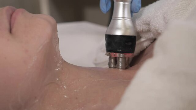 Hardware cosmetology professional cosmetologist rf lifting procedure in a beauty parlour. Anticellulite and lifting therapy with hardware cosmetology. Woman getting rf-lifting in a beauty clinic.