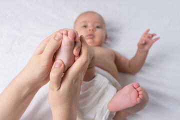 Masseur giving foot massage to baby. Selective focus