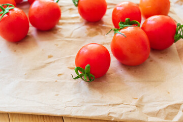 A bunch of cherry tomatoes on craft paper.