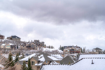 Mountain homes on a cold snowy setting beneath gray overcast sky in winter
