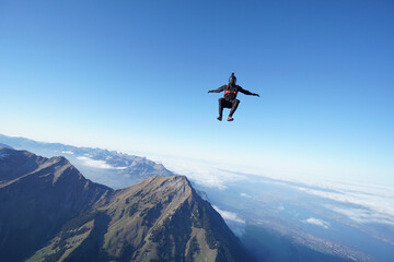 Fototapeta na wymiar Skydiver with camera mount freefalls through air