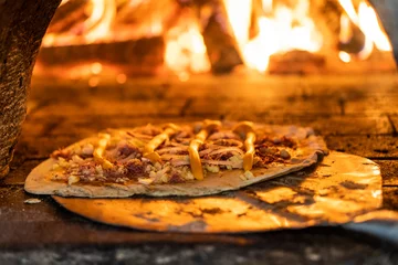 Foto op Plexiglas close up on pizza going to the wood oven, short depth of field © CESARVR